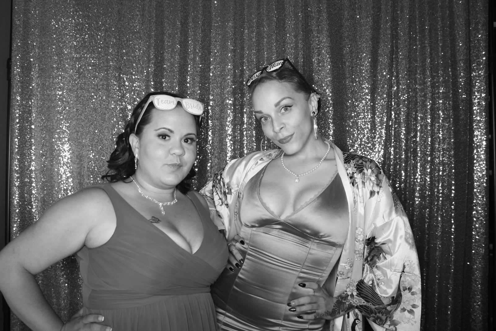 Guests pose for a black-and-white All Generations photo booth portrait.