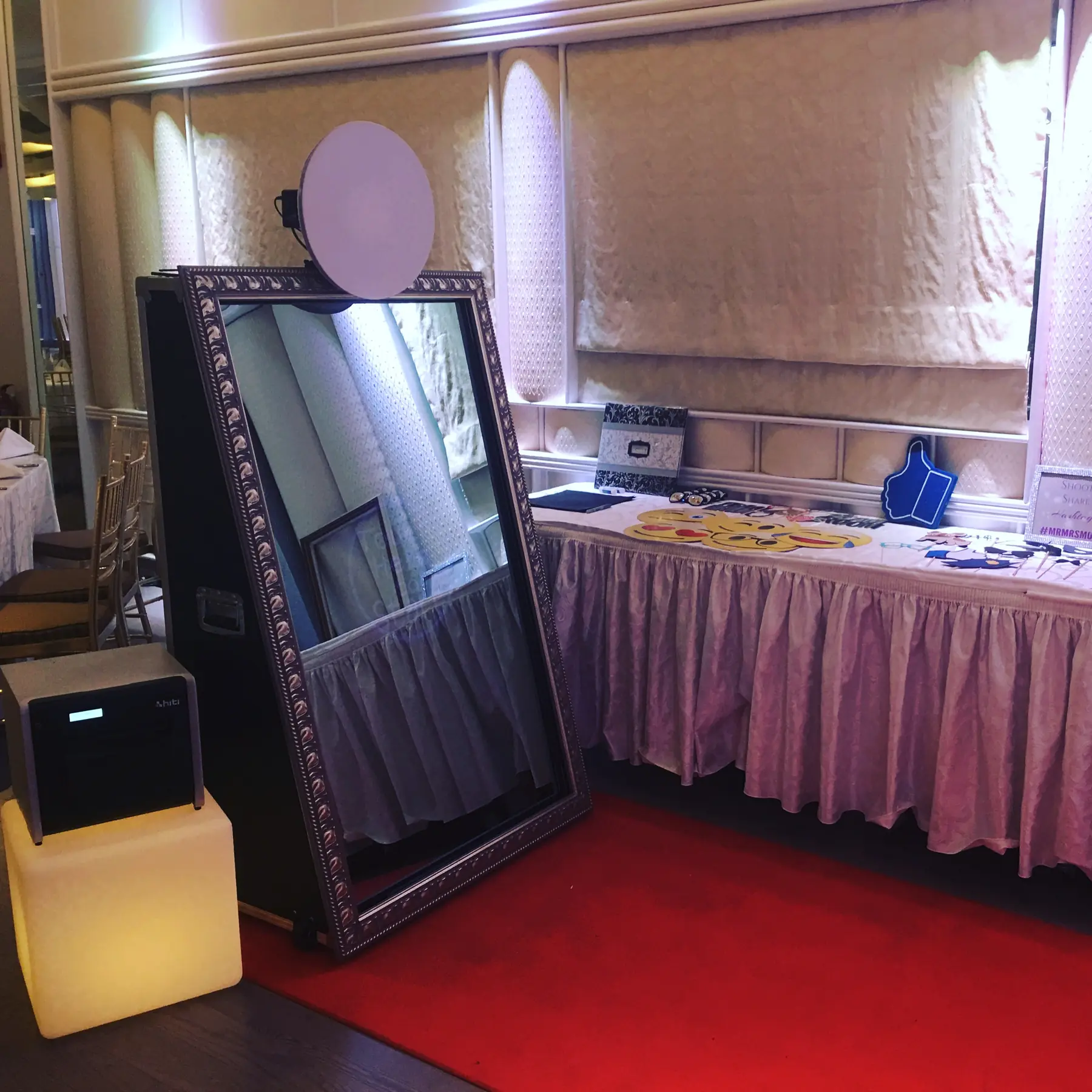 Guests use an interactive mirror photo booth at an event.